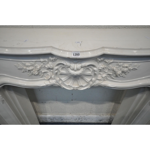 1260 - AN ITALIAN MARBLE EFFECT RESIN FIRE SURROUND, with foliate details, width 139cm x depth 27cm x heigh... 