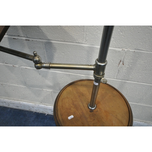 1264 - A REPRODUCTION MUSIC STAND, the tubular metal support holding an articulated arm and a fixed circula... 