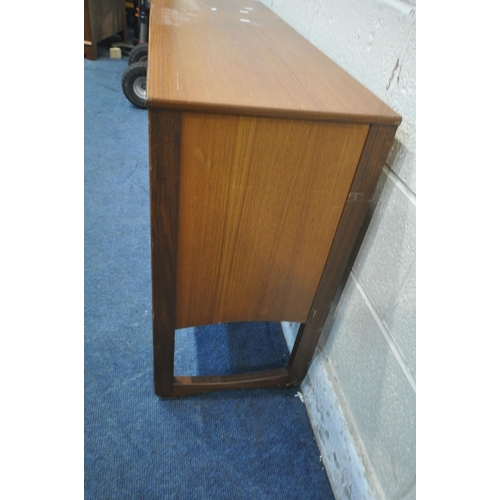 1271 - A MID CENTURY TEAK RECORD CABINET, the fall front door enclosing various divisions, raised on quadri... 