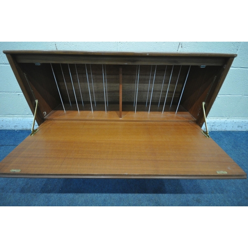 1271 - A MID CENTURY TEAK RECORD CABINET, the fall front door enclosing various divisions, raised on quadri... 