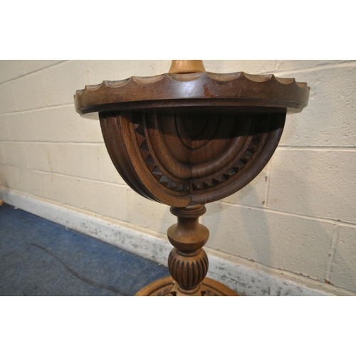 1276 - A LATE 20TH CENTURY OAK STANDARD LAMP, with geometric carvings, a circular shelf and base, raised on... 