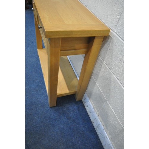 1280 - A LIGHT OAK SIDE TABLE with two frieze drawers, raised on block legs, united by an undershelf, width... 