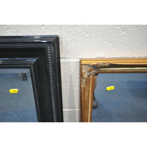 1282 - A GILT WOOD RECTANGULAR WALL MIRROR, 87cm x 69cm, a larger bevelled edge wall mirror, along with a b... 