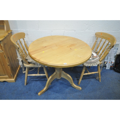 1293 - A PINE CIRCULAR KITCHEN TABLE, raised on a turned support and three legs, diameter 91cm x height 78c... 