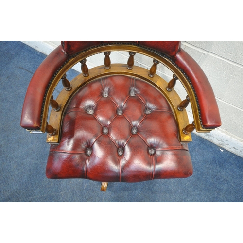 1299 - A REPRODUCTION OXBLOOD BUTTONED LEATHER BOW TOP SWIVEL OFFICE CHAIR, width 63cm x depth 62cm x heigh... 