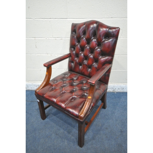 1300 - AN OXBLOOD BUTTONED LEATHER GAINSBOROUGH CHAIR, with arched back rest and open armrests, width 62cm ... 