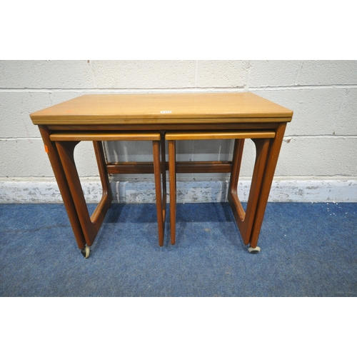 1312 - A.H. MCINTOSH, A MID CENTURY TRIFORM NEST OF TABLES, the largest table with a folding revolving top,... 