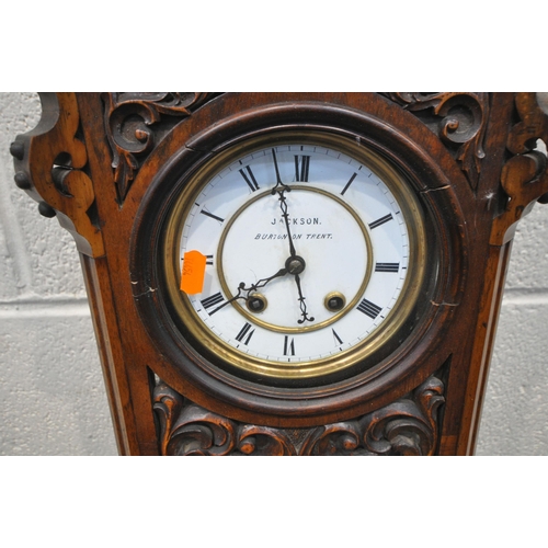 1320 - A LATE 19TH / EARLY 20TH CENTURY WALNUT WALL CLOCK, with an arched crest, flanked by twin finials, t... 