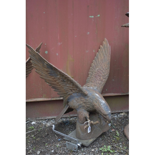 1002 - AN OPPOSING PAIR OF WEATHERED CAST IRON SCULPTURES, of a bird of prey with wings outspread, wings wi... 