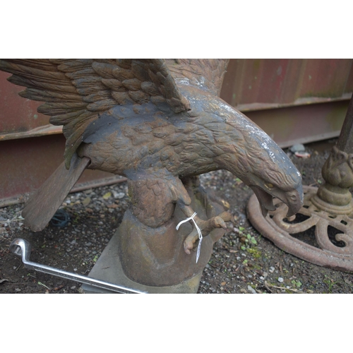 1002 - AN OPPOSING PAIR OF WEATHERED CAST IRON SCULPTURES, of a bird of prey with wings outspread, wings wi... 