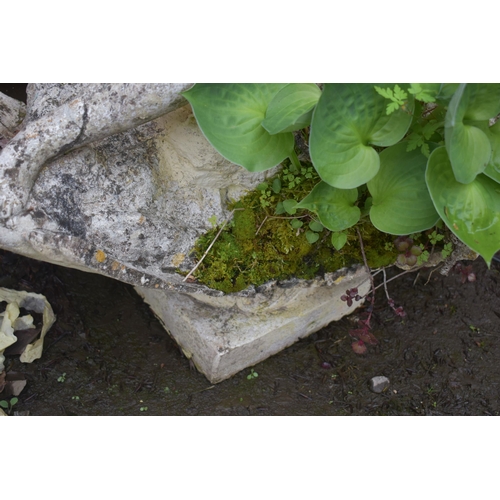 1010 - A WEATHERED COMPOSITE GARDEN WATER FEATURE, of a lady sitting on rocks within a shell, holding a she... 