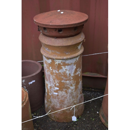 1014 - TWO SIZED TERRACOTTA CHIMNEY POTS, with toppers, tallest height 71cm, and two terracotta drain pipes... 