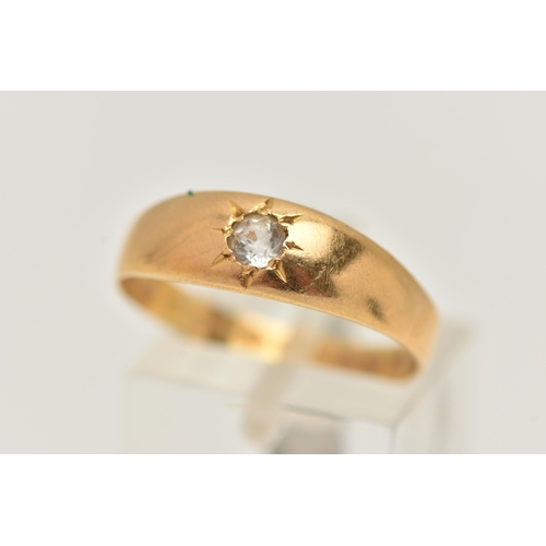 29 - A YELLOW METAL SINGLE STONE RING, star set with a colourless circular cut sapphire, to a polished ba... 