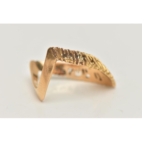 36 - A YELLOW METAL TEXTURED WISH BONE RING, textured V shape, and polished reverse, stamped 750, ring si... 