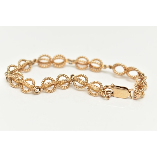 4 - A 9CT GOLD FANCY LINK BRACELET, rope twist open work links, fitted with a lobster clasp, part Sheffi... 