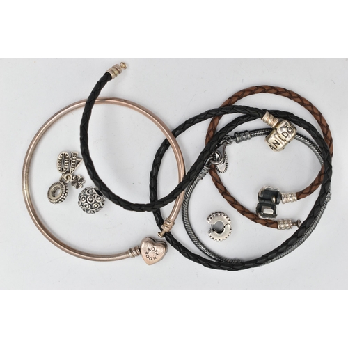 40 - FOUR PANDORA CHARM BRACELETS AND CHARMS, to include two woven leather examples, a bangle and an oxid... 