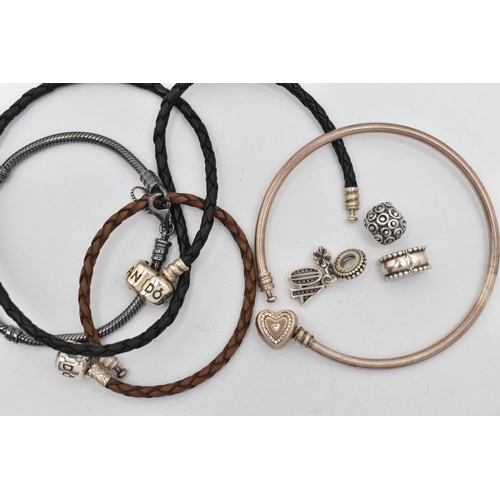 40 - FOUR PANDORA CHARM BRACELETS AND CHARMS, to include two woven leather examples, a bangle and an oxid... 