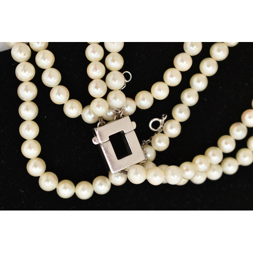 51 - A DOUBLE STRAND OF CULTURED PEARLS WITH DIAMOND CLASP, round white cultured pearls with pink underto... 