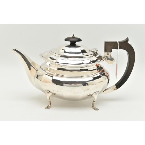 79 - A GEORGE V SILVER THREE PIECE TEA SET, of a faceted design, comprising of a teapot fitted with an eb... 