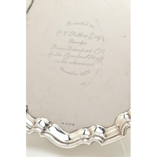 80 - AN ELIZABETH II SILVER PRESENTATION SALVER, of a circular form with wavy edge, engraving to the cent... 