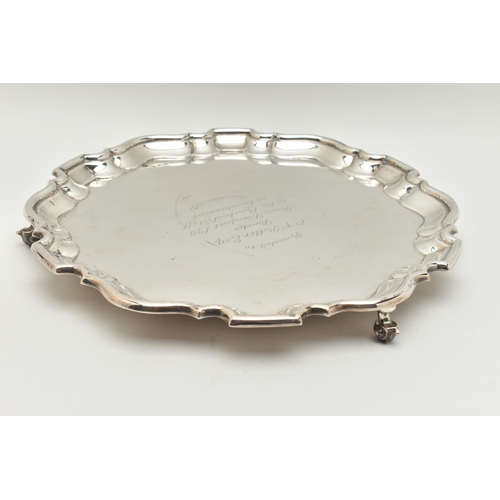 80 - AN ELIZABETH II SILVER PRESENTATION SALVER, of a circular form with wavy edge, engraving to the cent... 