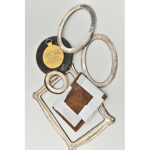 82 - SILVER PHOTO FRAMES, to include a circular photo frame hallmarked Birmingham, with photo, a rectangu... 