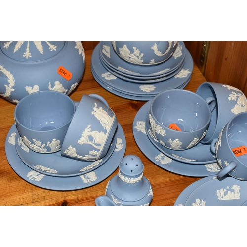 352 - A WEDGWOOD BLUE JASPERWARE TEA SET, comprising a teapot, covered sugar bowl, milk jug, sugar sifter ... 