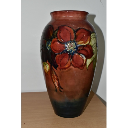 357 - A MOORCROFT POTTERY FLAMBÉ 'CLEMATIS' PATTERN VASE, of ovoid form, tube lined with red and purple cl... 