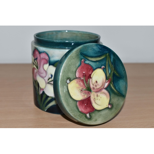 367 - A MOORCROFT POTTERY 'FREESIA' PATTERN COVERED JAR, of cylindrical form, tube lined with pale yellow ... 