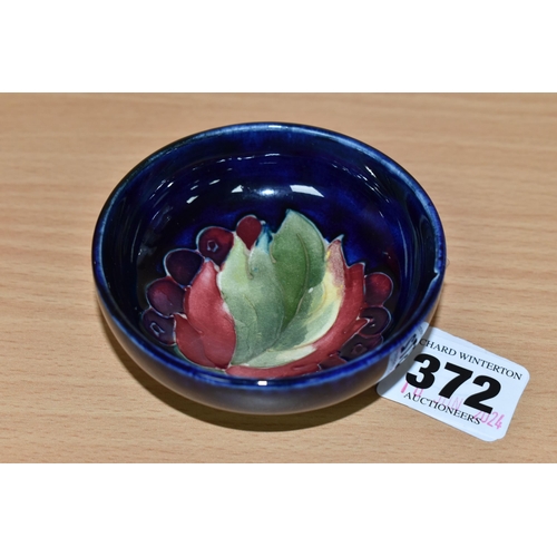 372 - A MOORCROFT POTTERY 'LEAF AND BERRIES' SMALL FOOTED BOWL, tube lined in the Leaf and Berries pattern... 