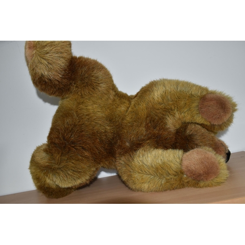 380 - A STEIFF URS BROWN BEAR, No.069673, soft plush brown bear in a lying position, button and tag to lef... 