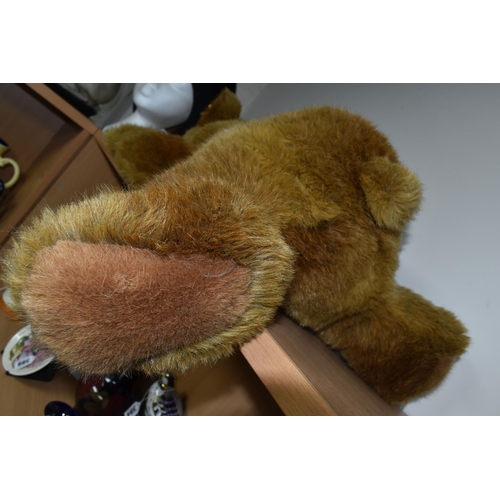 380 - A STEIFF URS BROWN BEAR, No.069673, soft plush brown bear in a lying position, button and tag to lef... 