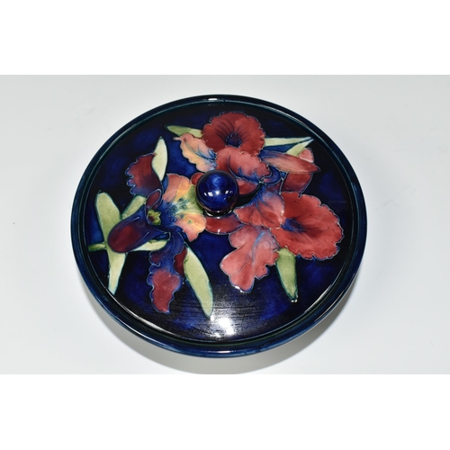 383 - A MOORCROFT POTTERY 'ORCHID' PATTERN COVERED BOWL, tube lined with pink and purple orchids on a blue... 