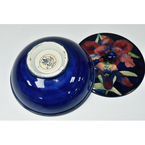 383 - A MOORCROFT POTTERY 'ORCHID' PATTERN COVERED BOWL, tube lined with pink and purple orchids on a blue... 