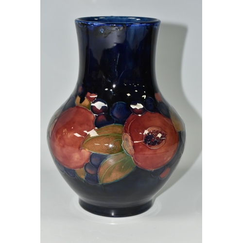 387 - A MOORCROFT POTTERY 'POMEGRANATE' PATTERN VASE, of baluster form, tube lined with pomegranates, berr... 