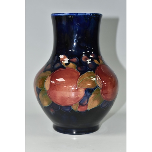 387 - A MOORCROFT POTTERY 'POMEGRANATE' PATTERN VASE, of baluster form, tube lined with pomegranates, berr... 