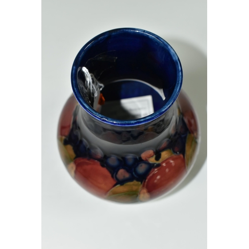 387 - A MOORCROFT POTTERY 'POMEGRANATE' PATTERN VASE, of baluster form, tube lined with pomegranates, berr... 