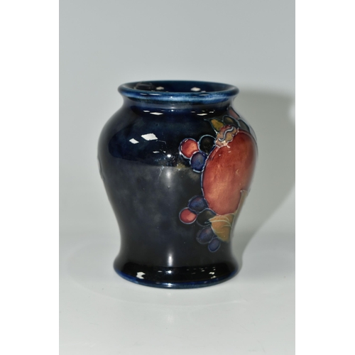 392 - A MOORCROFT POTTERY 'POMEGRANATE' PATTERN VASE, of small baluster form, tube lined with pomegranates... 