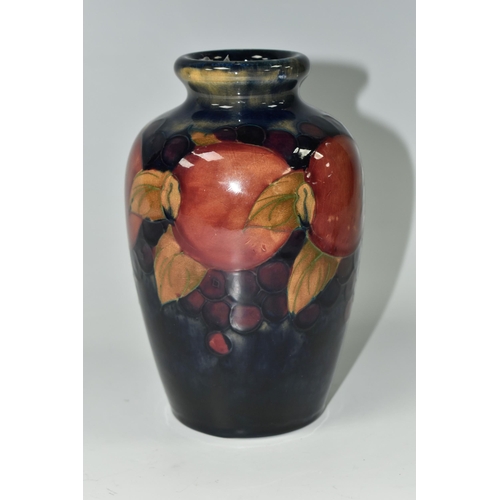 409 - A MOORCROFT POTTERY 'POMEGRANATE' PATTERN VASE, of ovoid form, tube lined with pomegranates, berries... 