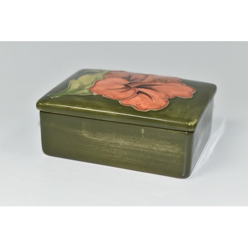 417 - A MOORCROFT POTTERY RECTANGULAR TRINKET BOX AND COVER, decorated in  Coral Hibiscus pattern on a gre... 