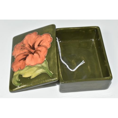 417 - A MOORCROFT POTTERY RECTANGULAR TRINKET BOX AND COVER, decorated in  Coral Hibiscus pattern on a gre... 