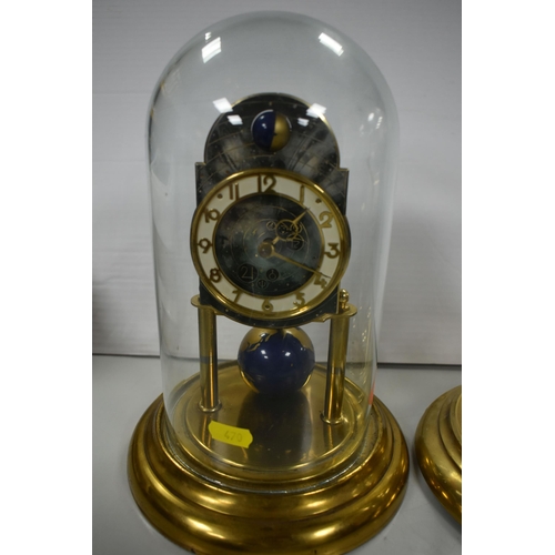 470 - TWO DOMED ANNIVERSARY CLOCKS, comprising a J Kaiser celestial themed anniversary clock, with pendulu... 