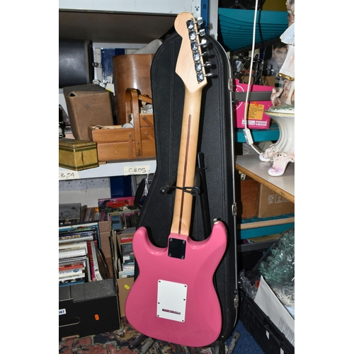 540 - AN ELECTRIC STRATOCASTER TYPE GUITAR IN PINK AND WHITE with faux Fender decals, no serial number or ... 