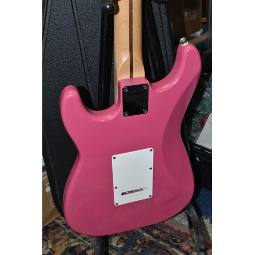 540 - AN ELECTRIC STRATOCASTER TYPE GUITAR IN PINK AND WHITE with faux Fender decals, no serial number or ... 