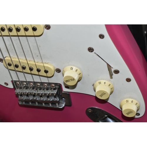 540 - AN ELECTRIC STRATOCASTER TYPE GUITAR IN PINK AND WHITE with faux Fender decals, no serial number or ... 