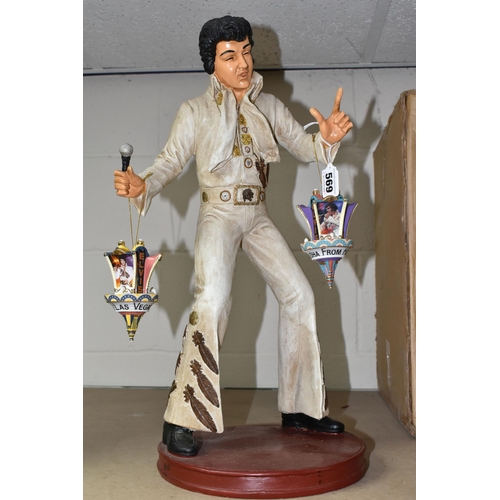 569 - A COMPOSITE FIGURE OF ELVIS PRESLEY WITH TWO HANGING ELVIS ORNAMENTS, the figure depicting Elvis per... 