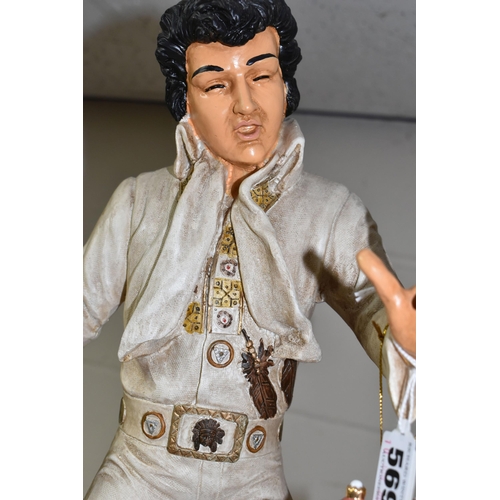 569 - A COMPOSITE FIGURE OF ELVIS PRESLEY WITH TWO HANGING ELVIS ORNAMENTS, the figure depicting Elvis per... 