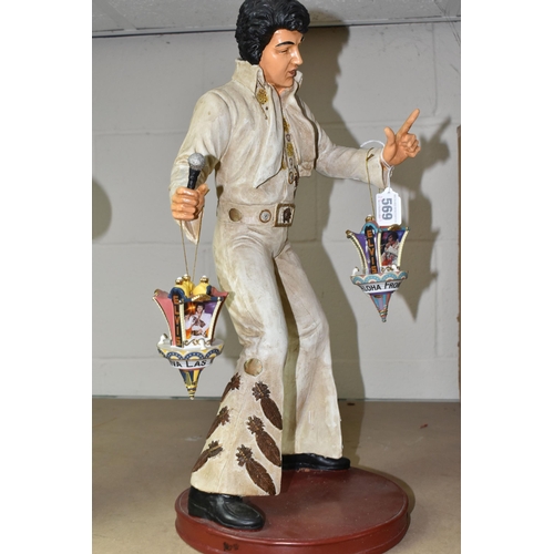 569 - A COMPOSITE FIGURE OF ELVIS PRESLEY WITH TWO HANGING ELVIS ORNAMENTS, the figure depicting Elvis per... 