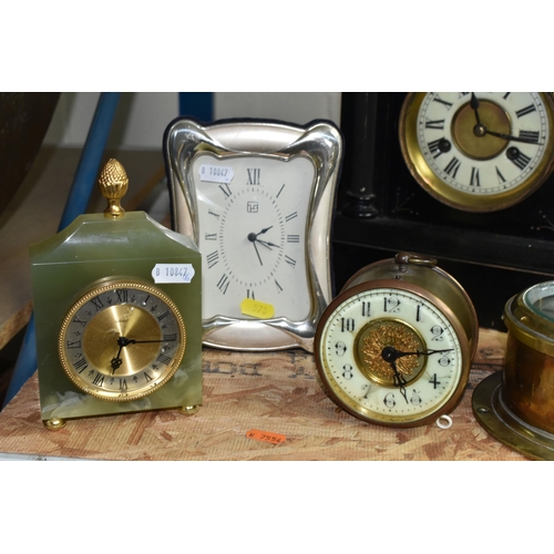 578 - A GROUP OF CLOCKS, comprising a late nineteenth century black wooden cased mantel clock, a brass bin... 