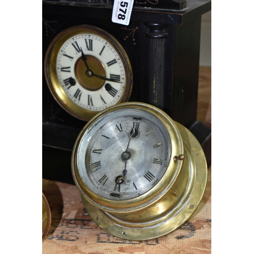 578 - A GROUP OF CLOCKS, comprising a late nineteenth century black wooden cased mantel clock, a brass bin... 